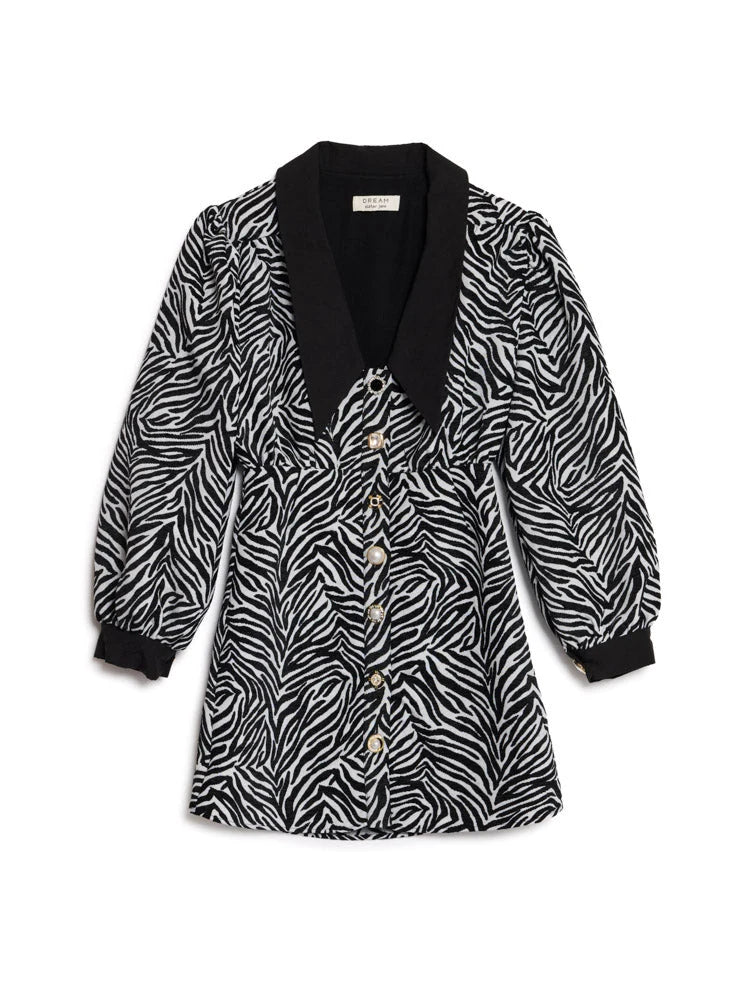 A long-sleeve button-front dress featuring a black and white zebra print pattern, a solid black collar, and black ribbed cuffs, displayed flat against a white background.